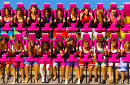 MUNICH, GERMANY - SEPTEMBER 23, 2014: The Oktoberfest in Munich is the biggest beer festival of the world. The visitors have lot of fun with many amusement huts and big carousels.のeditorial素材