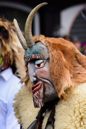 public carnival parade with colorful costumes at city Bad Hindelang in Bavaria, Germany