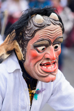 public carnival parade with colorful costumes at city Bad Hindelang in Bavaria, Germany