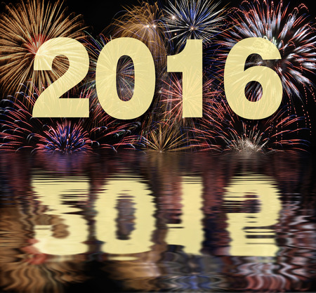 new year 2016 with fireworks and mirroring on water