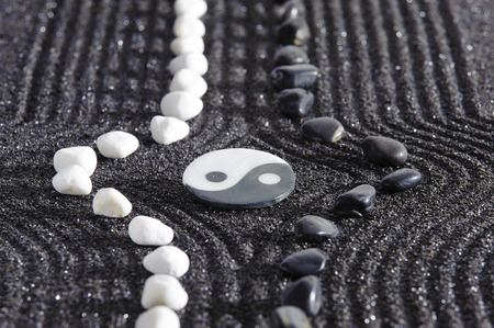Japanese ZEN garden with yin and yang stone in raked sandの写真素材