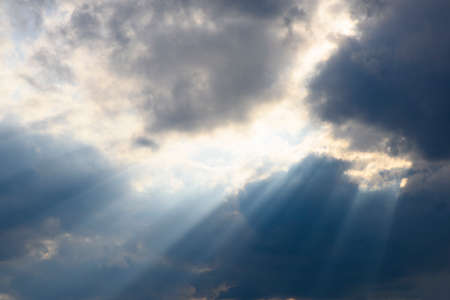 clouds on sky with dramatic sun raysの写真素材