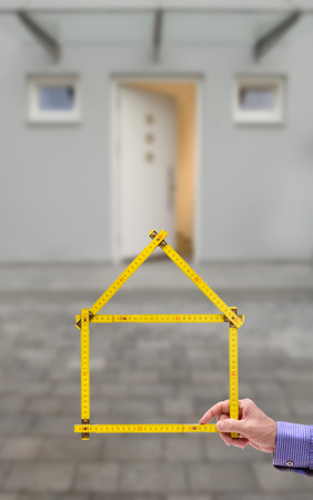 folded yardstick in hand of real estate agentの写真素材