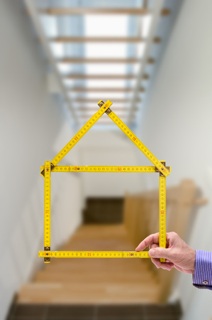 folded yardstick in hand of real estate agentの写真素材