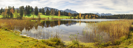 panoramic scene in Bavaria, Germany, with mountains mirroring in lakeの写真素材