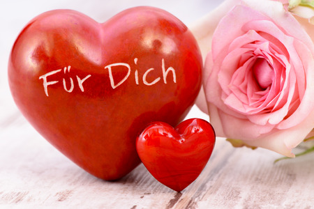 rose flower and heart with inscripton in german language: for youの写真素材