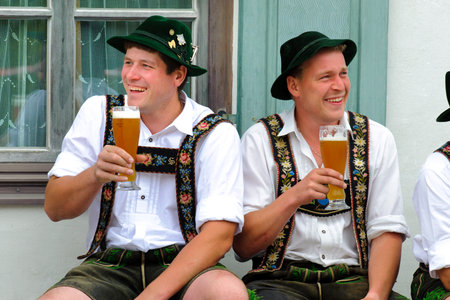 In many villages of Bavaria it is an historical customs to erect a high and decorated tree at 1. May by local men and with muscle power, clothed in traditional bavarian dress with short leather trousers and white shirts. After erecting the tree, men and w