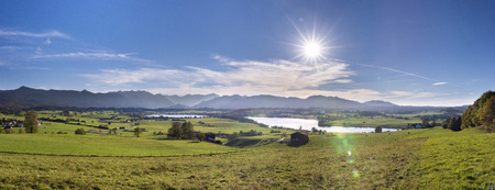 panoramic scene at Bavarian alps mountain range and lake Riegseeの写真素材