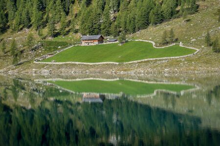 Reflection of a farm in the lakeの写真素材