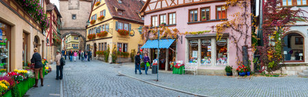 Rothenburg ob der Tauber, Germany / Bavaria - August 21, 2020: Panoramic view of the medieval old town of Rothenburg with beautiful shops in historic half-timbered houses.のeditorial素材