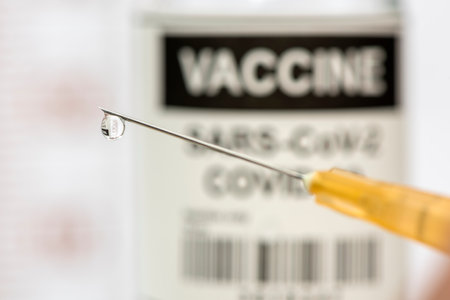 vaccination with serum and syringe against COVID-19 virusの写真素材