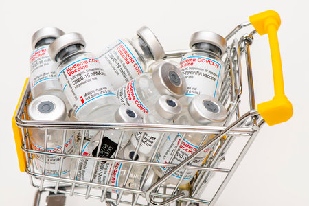 Vials with the Moderna and Pfizer-Biontech Covid-19 vaccine are laying in a shopping trolley as symbolのeditorial素材
