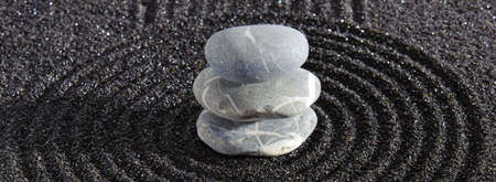 Japanese ZEN garden with yin yang stone in textured sand
