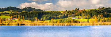 beautiful rural landscape in Bavaria with mountain range and meadow at springtimeの写真素材