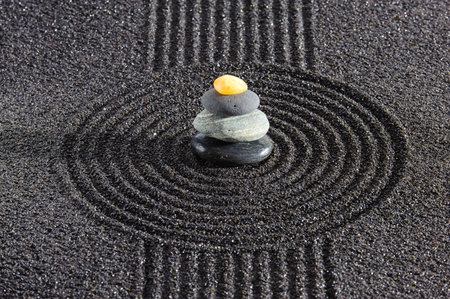 Japanese zen garden with stone in textured sandの写真素材