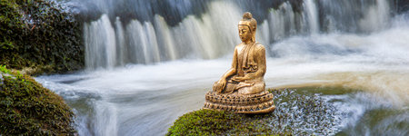 Buddha sculpture sitting in flowing waterの写真素材