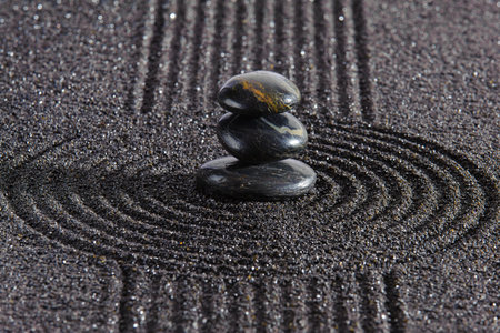 Japanese Zen garden with stone in textured sandの写真素材