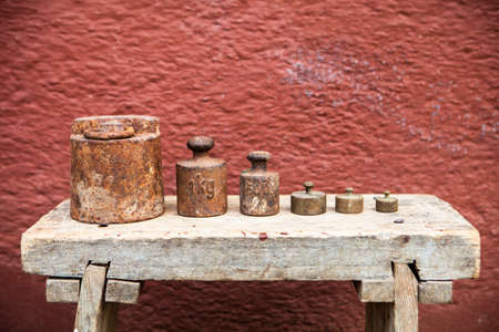 Old, rusty weights on the benchの写真素材