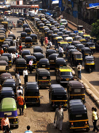 MUMBAI, INDIA-JULY 17, 2008: Crowd and traffic jam on the outer local street. The street is full...