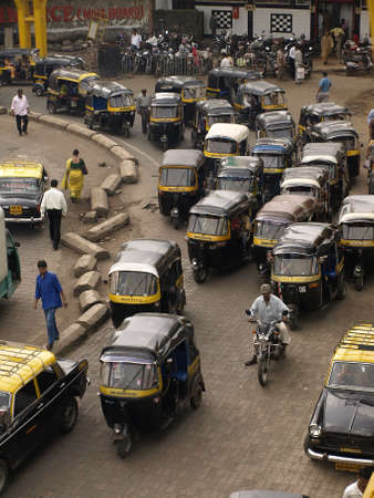 MUMBAI, INDIA-JULY 17, 2008: Crowd and traffic jam on the outer local street. The street is full...