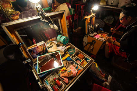BANGKOK, THAILAND - JANUARY 18: The box of cosmetic set and a Chinese actor is doing make up before the show of traditional Chinese opera on January 18, 2015のeditorial素材