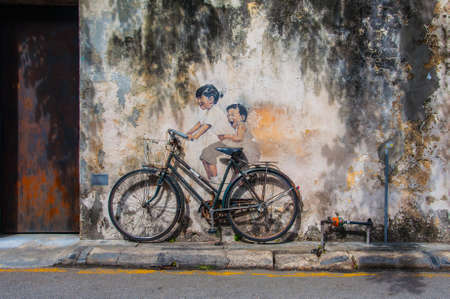 Georgetown, Penang, Malaysia - February 19, 2015: "Little Children on a Bicycle" street art on wall by Lithuanian artist Ernest Zacharevicのeditorial素材
