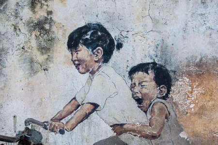 Georgetown, Penang, Malaysia - February 18, 2015: "Little Children on a Bicycle" street art on wall by Lithuanian artist Ernest Zacharevic in George Town, Penang, Malaysia.のeditorial素材