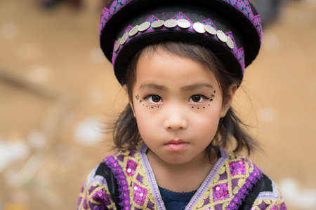A little girl of local mountaineer tribe 'Hmong' is dressing with traditional costume in Luang Prabang, Laos.のeditorial素材