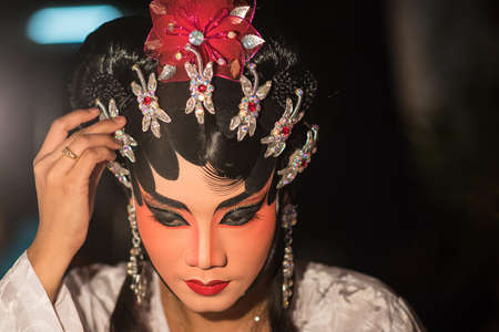A Chinese actress is doing make up before the show of traditional Chinese opera.のeditorial素材