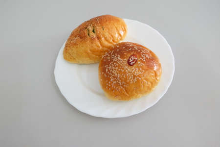 Bread on white dish against gray backgroundの写真素材