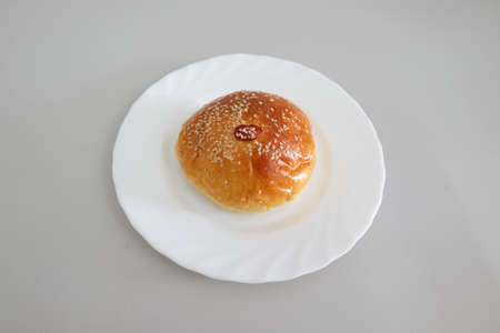 Large loaf of bread on white dish against gray backgroundの写真素材
