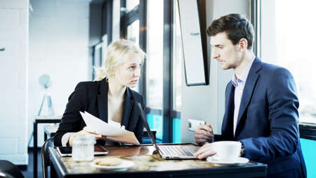 Businesswoman Explains Something to Her Partner