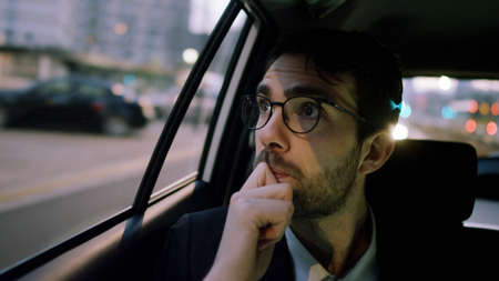 Young Businessman Looking Through a Window
