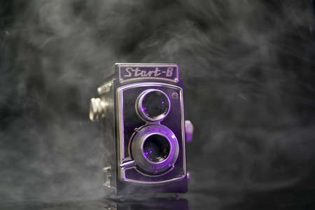 Caen, France, September 09 2019: old camera on a white background with a smog on the table, WZFO...