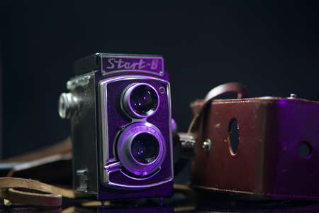 Caen, France, September 09 2019: old camera on a white background with a smog on the table, WZFO...
