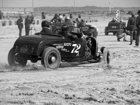 Ouistreham, France September 26, 2020 Normandy Beach Race second edition of old car and motorbike rallies on the beach, black and white photo of FORD car in actionのeditorial素材