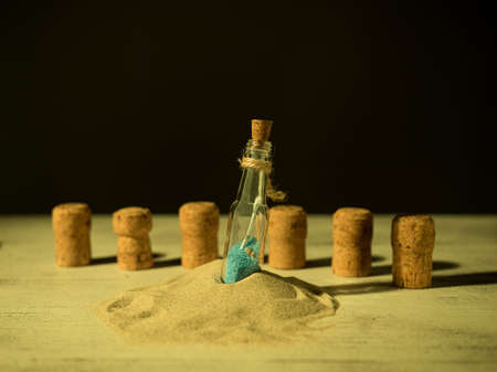 Bottle locked inside a rolled up letter, warm light, close-up