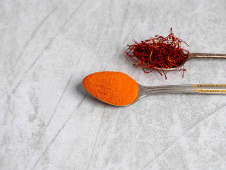 Saffron spice powder on spoons. Place for text. view from above. Food or cooking concept, bright backgroundの写真素材