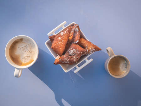 Coffee and cake dessert on the table in the sunshine, top viewの写真素材