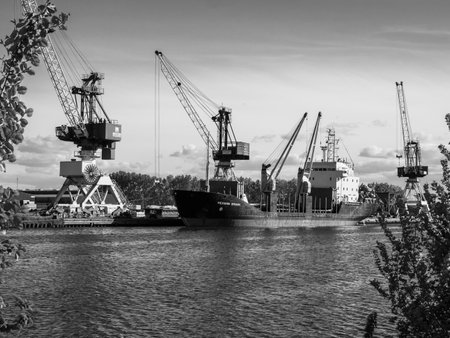 Caen, France May 2021. Unloading of a ship under the Russian flag Mekhanik Brilin, French port of unloading on the Canal de Caen. 4k high definition movieのeditorial素材