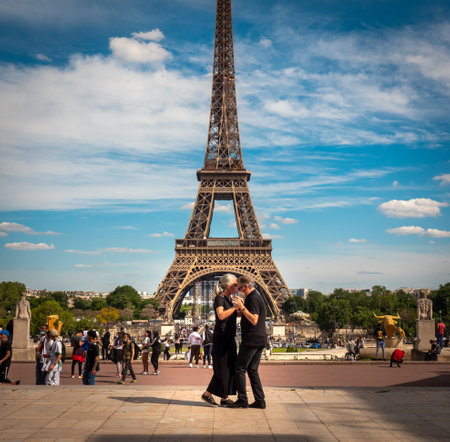 Paris, France, May 2021. Dancing Argentine couples tango on the Tracadero square in the background...