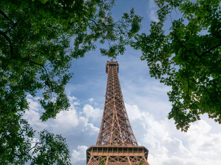 Paris, France, May 2021. The Eiffel Tower from the perspective between the trees, photo from the bottom, a lot of green on the sideのeditorial素材