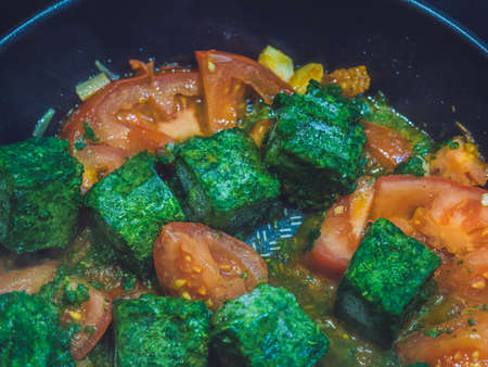 spinach with tomatoes in a pan vegetarian food, healthy foodの写真素材