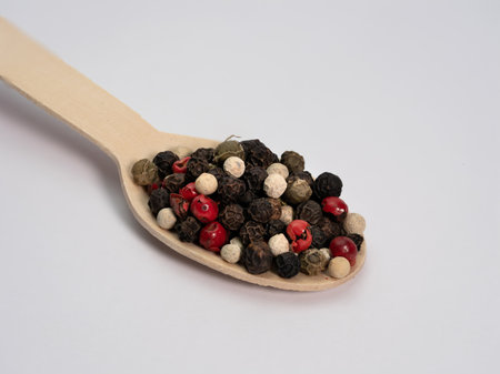 Wooden spoon with powdered cinnamon on a white backgroundの写真素材