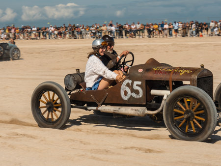 Ouistreham, Normandy, France, September 2021. NORMANDY BEACH RACE. Riders in their cars on the Ouistreham beach during the race. Sun fans in the background, old clothes, retro styleのeditorial素材