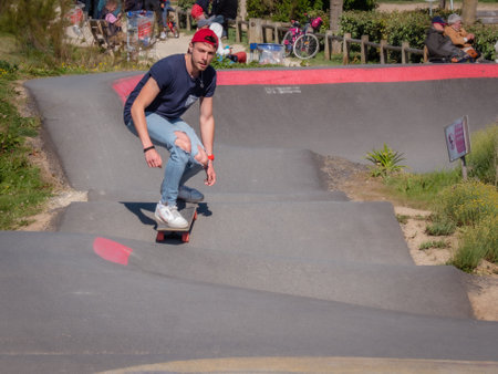 Merville, France, May 2022. Man with a helmet riding a BMX bike in the skate park. Sunny day, relaxation, sports lifestyleのeditorial素材
