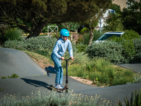 Merville, France, May 2022. Man with a helmet riding a BMX bike in the skate park. Sunny day, relaxation, sports lifestyleのeditorial素材
