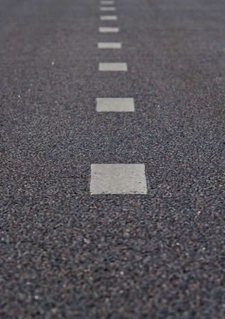 Asphalt road with a marking strips black and white color