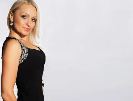 Serious fashion woman isolated over grey background horizontalの写真素材