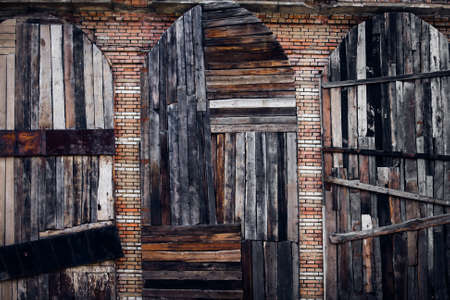 three vintage doors from the old boards on a brick wall background